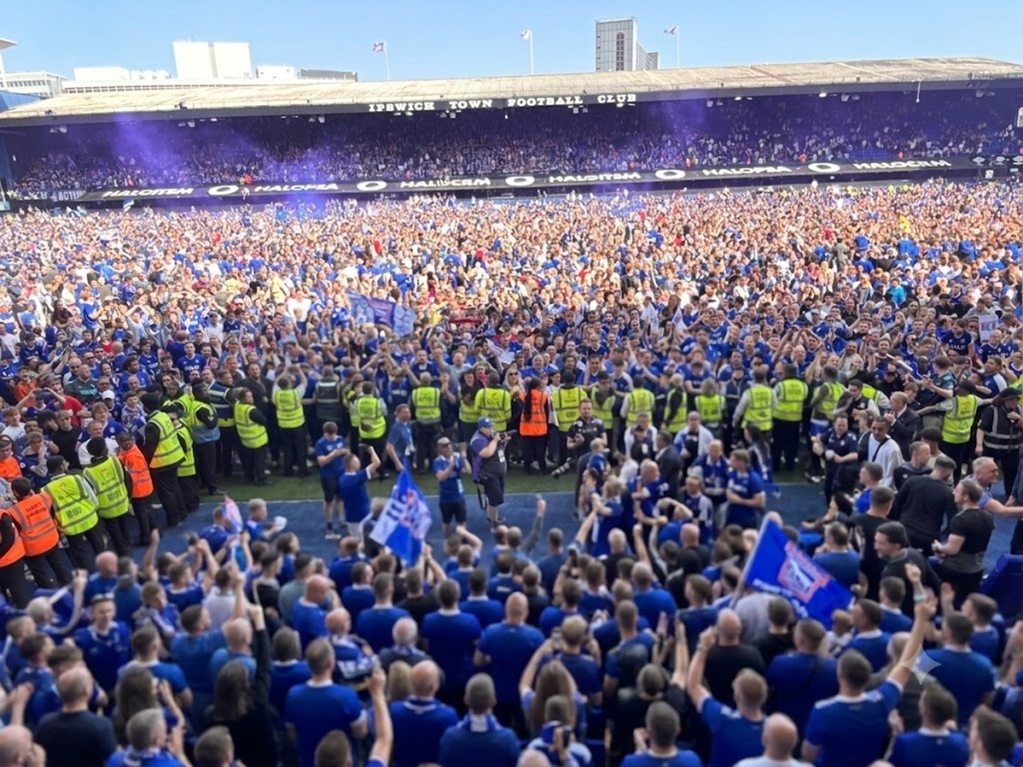 Ipswich Town fans flood the Portman Road pitch on promotion day